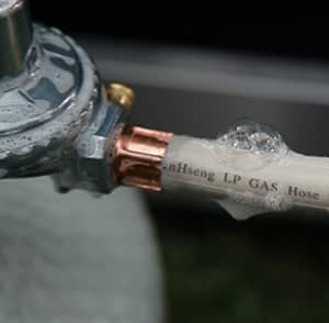 Soapy water leak test on gas hose